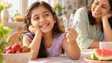 Girl choosing between Dirty Good Strawberry, Watermelon and Berry Blast chapsticks, the flavours in the Fruity Squad