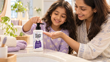 Mother and daughter with a pump bottle of Dirty Good Tangle Free Conditioning Shampoo on the bathroom counter