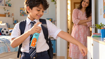 Boy in school uniform spritzing Dirty Good Ocean Mist Kids Body Mist at arm's length onto his sleeve