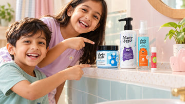 The four pieces of The First Splash | Nautical Breeze Bath Wash, Shampoo & Ocean Mist on a bathroom shelf, with two kids pointing