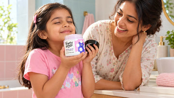 Girl smelling an open jar of Dirty Good Cotton Candy Kids Body Wash with her eyes closed
