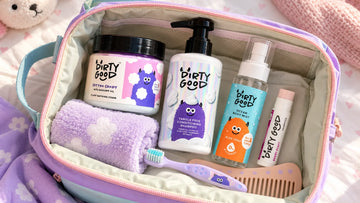 Kids travel pouch packed with the pieces of The First Splash | Cotton Candy Bath Wash, Shampoo & Ocean Mist plus a toothbrush and comb