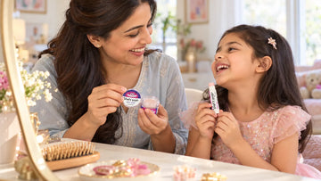 Mother and daughter getting ready together at a dressing table with a Dirty Good Berry Blast Kids Lip Balm tin and a Berry Blast chapstick, the pair in the Berry Me & Mini I Kids Lip Combo
