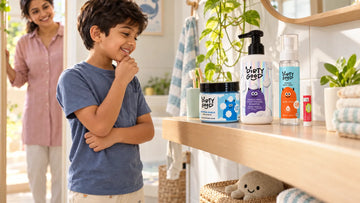 Boy looking proudly at his own shelf with the four pieces of The First Splash | Nautical Breeze Bath Wash, Shampoo & Ocean Mist