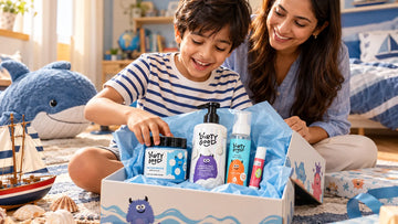 Boy surrounded by ocean toys opening The First Splash | Nautical Breeze Bath Wash, Shampoo & Ocean Mist