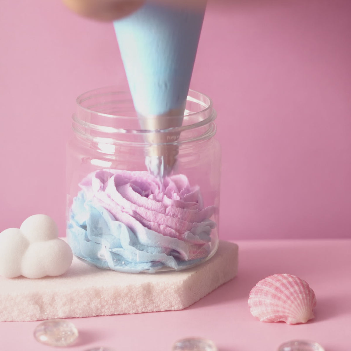 Cotton Candy bath foam piped into a jar in four pastel layers, finished with a cloud on top