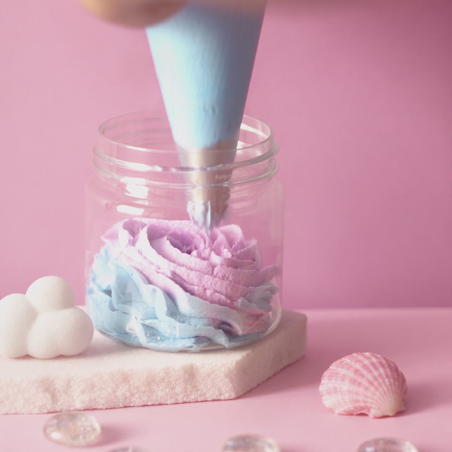 Cotton Candy bath foam piped into a jar in four pastel layers, finished with a cloud on top
